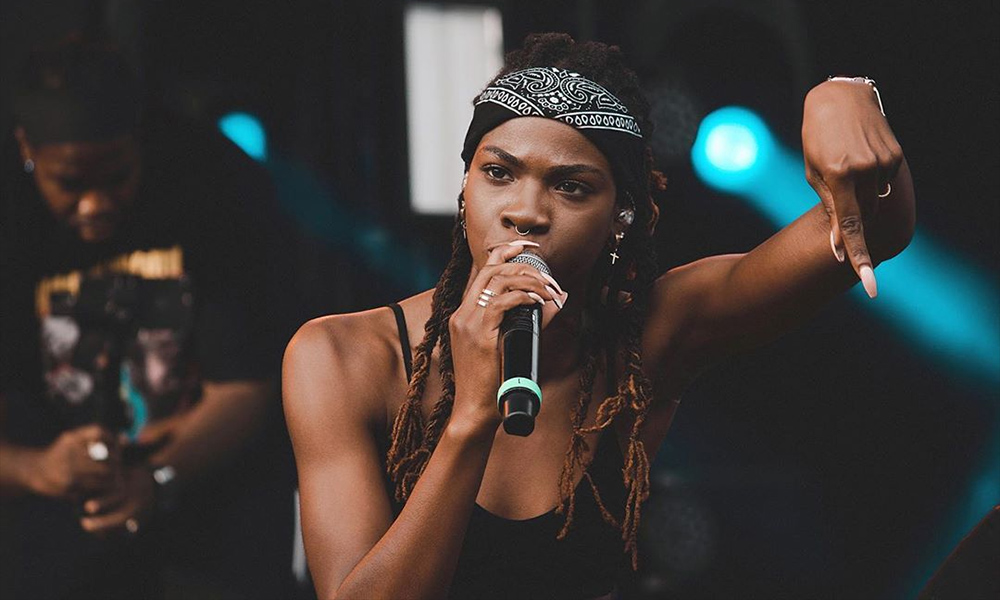 Image of rap star Haviah Mighty, black woman, singing.