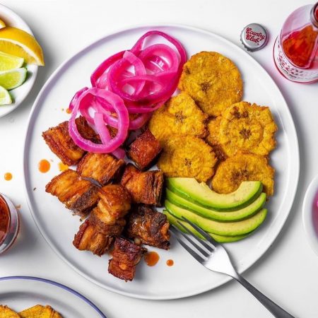 Chicharron, a Caribbean food with plantains, avocado, onion