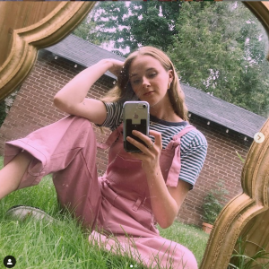 Image of young adult woman looking at cell phone